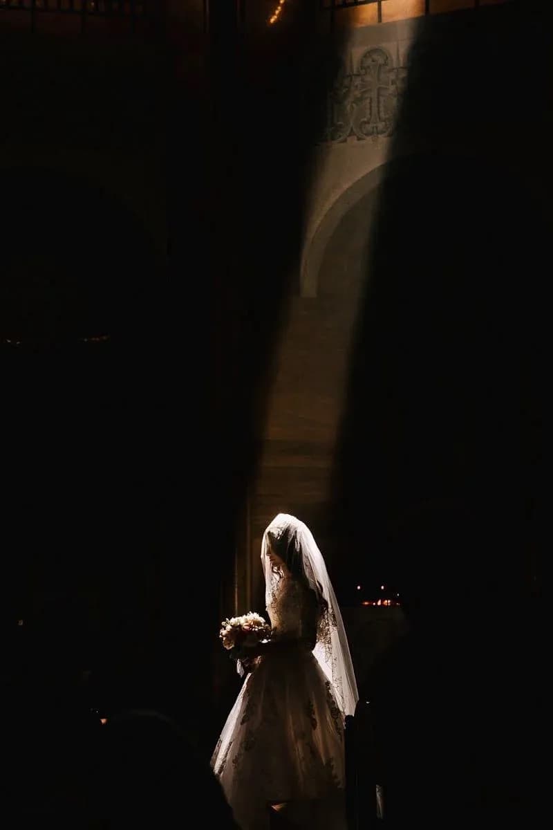 Bride standing in a softly lit entrance