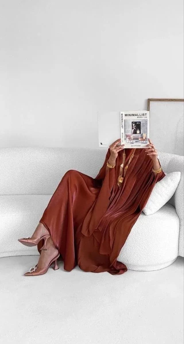 Founder seated in a brown dress